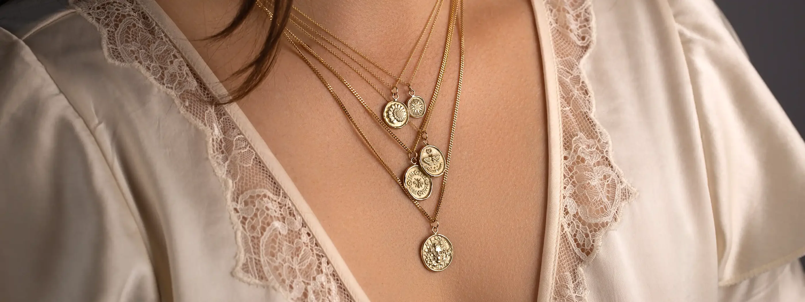 Layered Pyrrha gold talisman necklaces